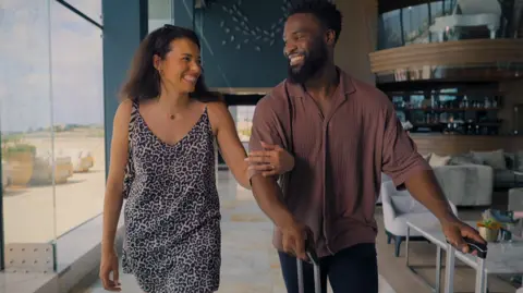 Netflix Katisha and Javen linking arms and smiling 