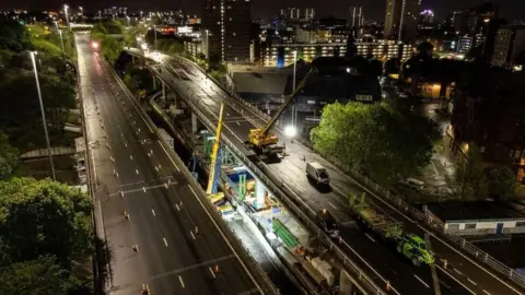 Transport Scotland Roadworks taking place on a deserted stretch of motorway at night.