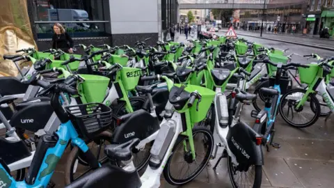 Getty Images Lime and Human Forest e-bikes parked across the pavement on 8 October 2024 in London. 