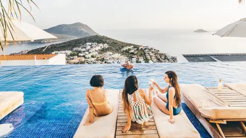 Getty Images Women having fun at a pool 