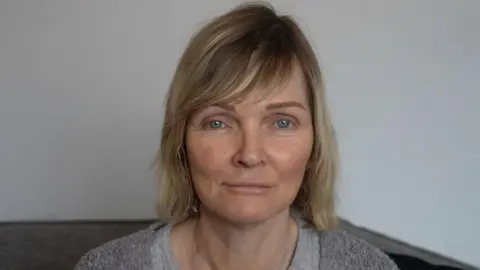 Hilary, a woman with blonde hair, looking at the camera.