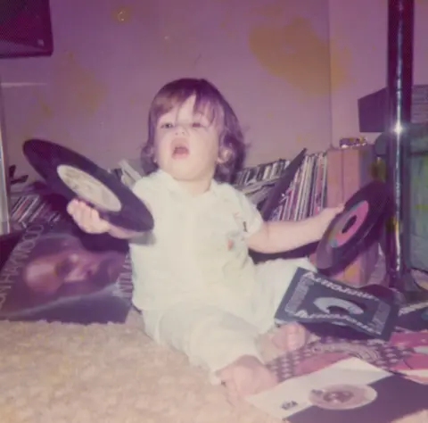 Mark Ronson Mark Ronson as a toddler, holding up several 7-inch singles