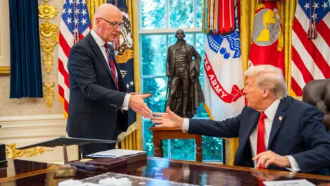 Scottish government John Swinney and Donald Trump shake hands in the Oval Office