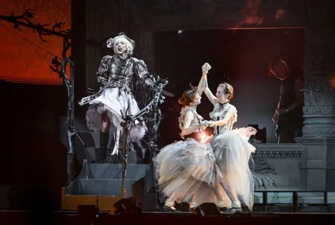 Getty Images Emma Myers and Evie Templeton on stage with Lady Gaga