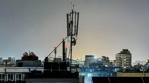 Getty Images A general view shows a telecommunications antenna installed for internet services on the rooftop of a house in Kabul