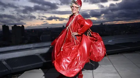 Getty Images Prue Leith wearing an red RAF parachute that has been remade into a dress.