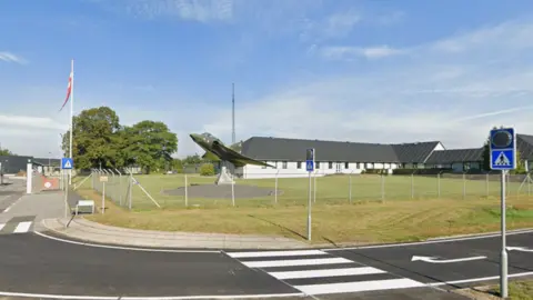Google A model plane mounted at the entrance of the Karup Air Base in Denmark
