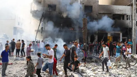 Reuters Palestinians gather at the site of Israeli strikes on residential buildings, amid an Israeli military operation, in Gaza City September 22