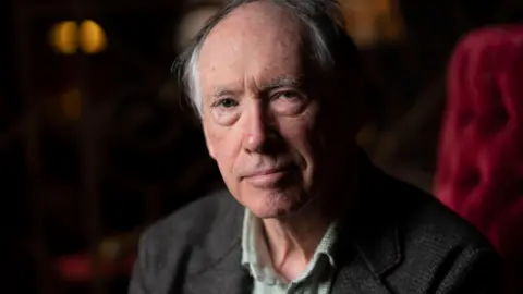 Getty Images Ian McEwan wearing a dark grey blazer and a light green checked shirt.