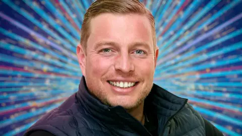 PA Media Thomas Skinner wearing a black gilet in a Strictly publicity photo