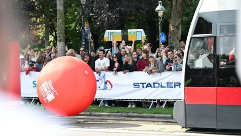 Reuters A tram approaches a large red ball, which it is intending to hit into large inflatable pins
