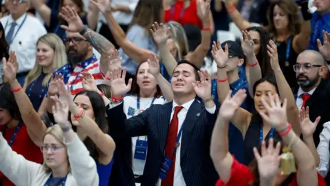 EPA Attendees singalong to Christian performers during the public memorial service of political activist Charlie Kirk