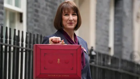 Reuters The Chancellor Rachel Reeves standing in Downing Street in October 2024 with the ministerial red box containing her first Budget speech. 