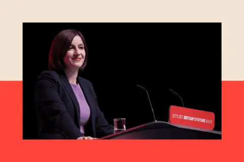 Reuters Bridget Phillipson, wearing a black blazer and a purple top, stands at a lectern in front of a black background while delivering a speech.