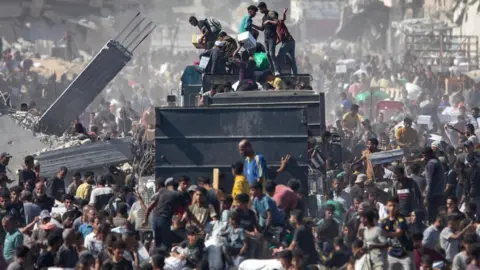 EPA Palestinians take aid supplies from a truck that arrived in Khan Younis in the southern Gaza Strip