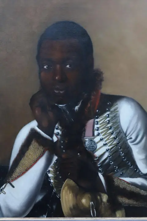 Lincoln Conservation A portrait of a black man in 19th Century military dress, holding a cymbal  