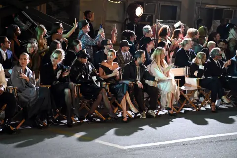 Getty Images Gwyneth Paltrow and Miley Cyrus sitting on the front row at the Vogue World show along with other audience members enjoying the show 