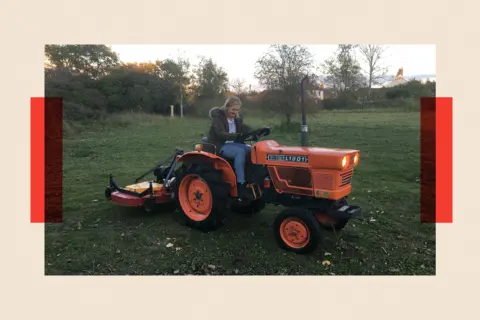Martha on a small orange tractor 