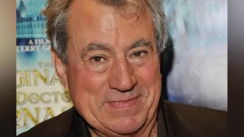 Getty Images Terry Jones pictured smiling at a film premiere photocall
