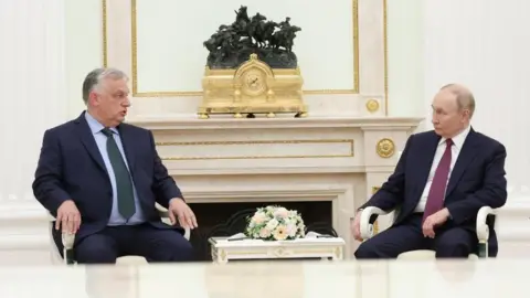 Reuters File image of Viktor Orban and Vladimir Putin talking during a meeting