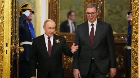Alexander Zemlianichenko/Pool via REUTERS Russian President Vladimir Putin and Serbia's President Aleksandar Vucic enter the hall during their meeting in Kremlin, Moscow, Russia, Friday, May 9, 2025