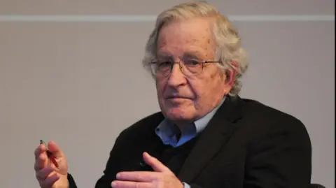Redferns via Getty Images Linguist Noam Chomsky gestures with his hands as he speaks at the British Library in 2013.