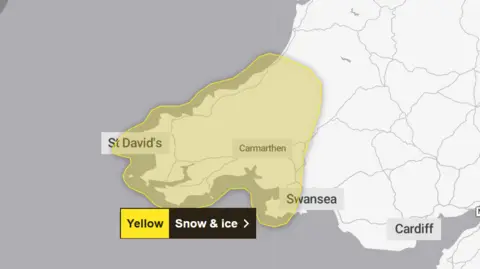 Met Office A map of Wales with patches of yellow across the south west of the country which says Yellow snow and ice warning. 