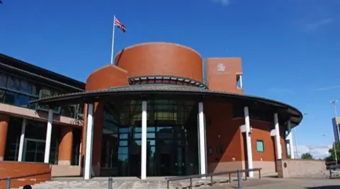 Ian Taylor/Geograph General view of the red-bricked and modern Preston Crown Court, on a sunny day with a blue sky