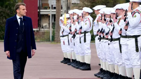Shutterstock French President Emmanuel Macron reviews the 27th Mountain Infantry Brigade in Varces, France, on November 27, 2025. 