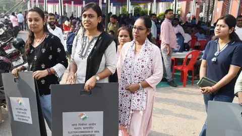 Getty Images Polling officials during collection of election material at a distribution centre ahead of the Bihar Assembly Elections 2025 in Patna, India.