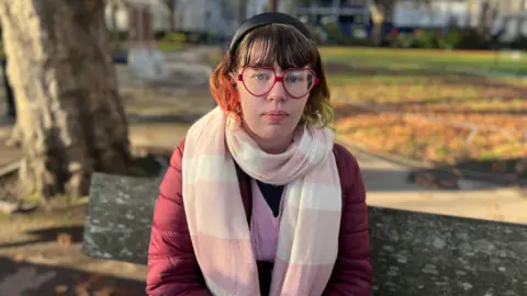 BBC Kerrie Portman sat on a park bench