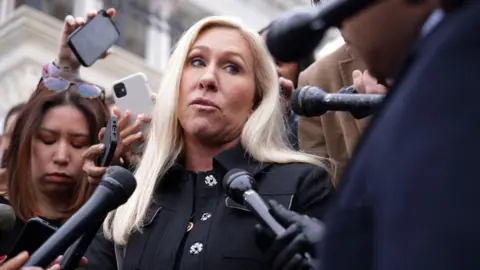 Getty Images Marjorie Taylor Greene speaks to reporters outside the US Capitol in March