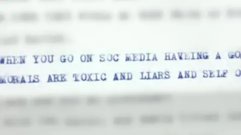 Image shows two lines of capitalised, typewritten text, surrounded by other text that is blurred. The text reads "WHEN YOU GO ON SOC MEDIA HAVEING A GO..." then the second line is visible from the words "MORALS ARE TOXMIX AND LIARS AND SELF".