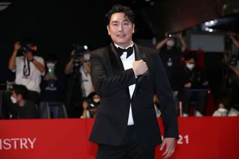 Getty Images  Cho Jin-woong in a black suit and bow tie poses on a red carpet