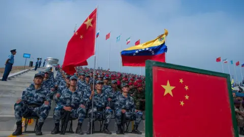 Getty Images Chinese military men surrounded by Chinese and Venezuelan flags
