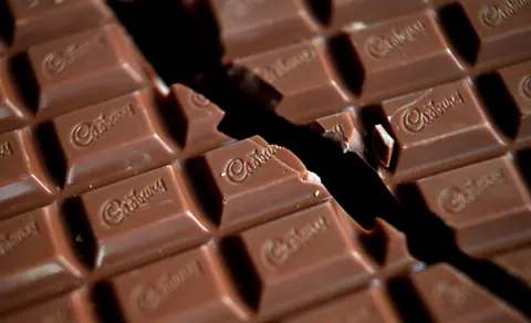 Getty Images In this photograph illustration a bar of Cadbury's Dairy Milk chocolate without a wrapper is broken in half