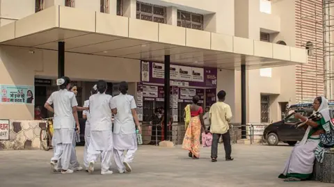 Getty Images Nurses, patients and attendants walking outside the building of the state-run hospital in India's eastern state of Jharkhand where five children suffering from thalassemia were infected with HIV after receiving blood transfusions in October 2025