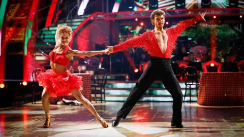George Clarke and Alexis Warr in red outfits performing on Strictly