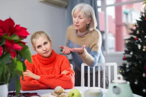 Getty Images Mother scolds her adult daughter while staying at Christmas
