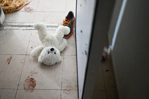Getty Images A teddy bear is seen left on the ground near the bomb shelter of a kibbutz home attacked by Hamas