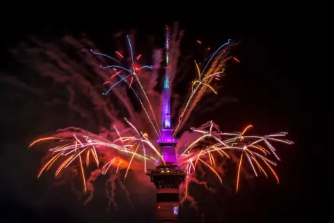 Shutterstock A firework display from the top of Auckland's Sky Tower welcomes in the New Year
