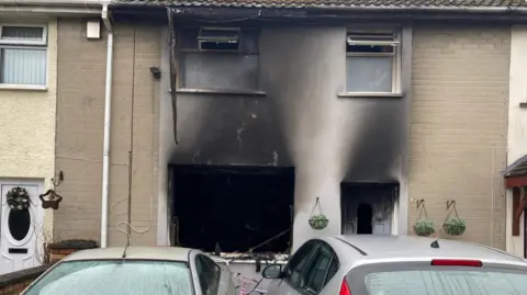 BBC A house that has been damaged by a fire.