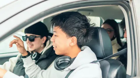 Getty Images A stock image of young people in a car