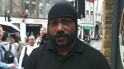 Shaun Thompson stands outside London Bridge tube station