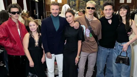 Getty Images (L-R) Cruz Beckham, Harper Beckham, David Beckham, Victoria Beckham, Romeo Beckham, Brooklyn Beckham and Nicola Peltz Beckham attends the Victoria Beckham Spring/summer 2023 Runway show in Val-de-Grace on September 30, 2022 in Paris, France. (Photo by Darren Gerrish/WireImage for Victoria Beckham )
