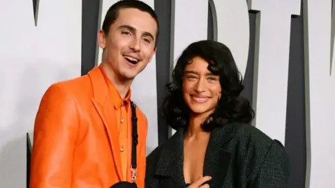 Getty Images US-French actor Timothee Chalamet (L) and US-German actress Odessa A'zion attend the premiere of Marty Supreme in Los Angeles, California, on December 8, 2025.