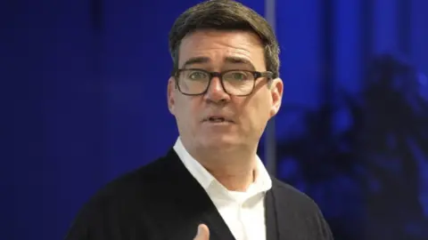 PA Media Andy Burnham speaking at an event