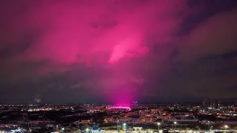 Getty Images An aerial shot of Birmingham city centre which shows a vivid pink glow, coming from the St Andrews football ground, being reflected off clouds above it, sending the whole sky pink