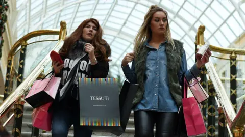 Getty Images Two women shopping in Manchester's Trafford Centre.
