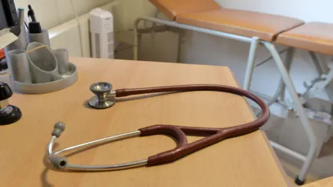 PA Media A doctors stethoscope on a table in a GP consultation room